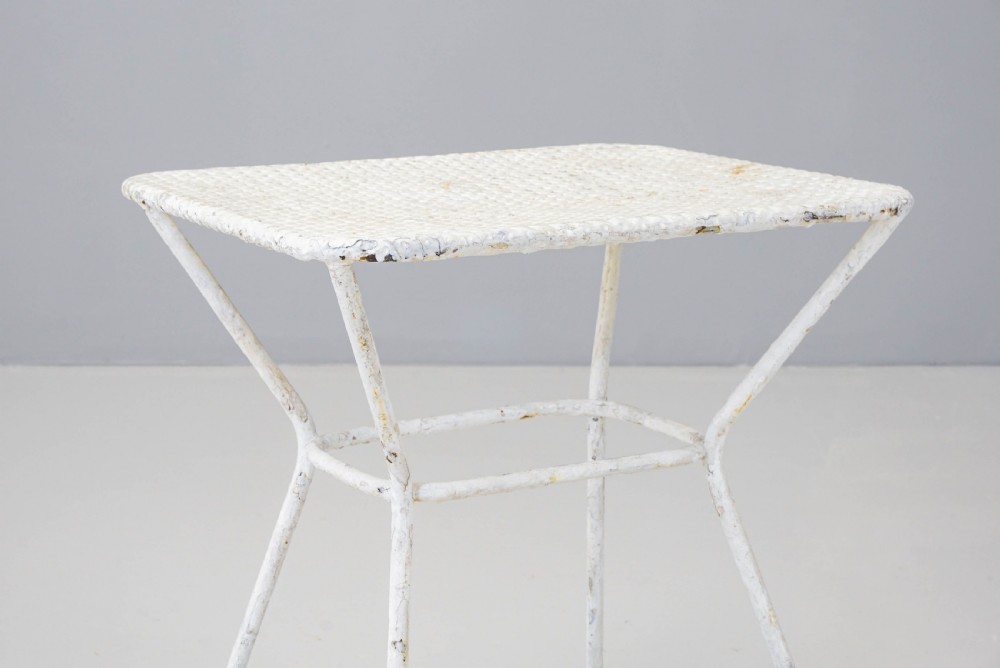 A pair of mid-century white painted metal side tables with perforated mesh rectangular tops and splayed tubular legs connected by a central circular ring. View IV