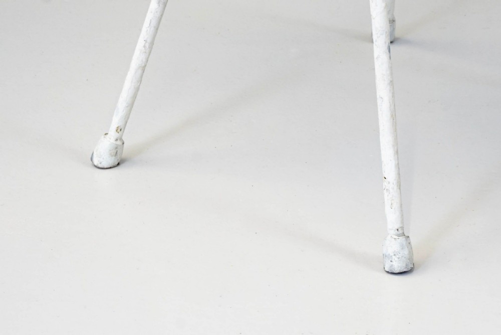 A pair of mid-century white painted metal side tables with perforated mesh rectangular tops and splayed tubular legs connected by a central circular ring. View VII