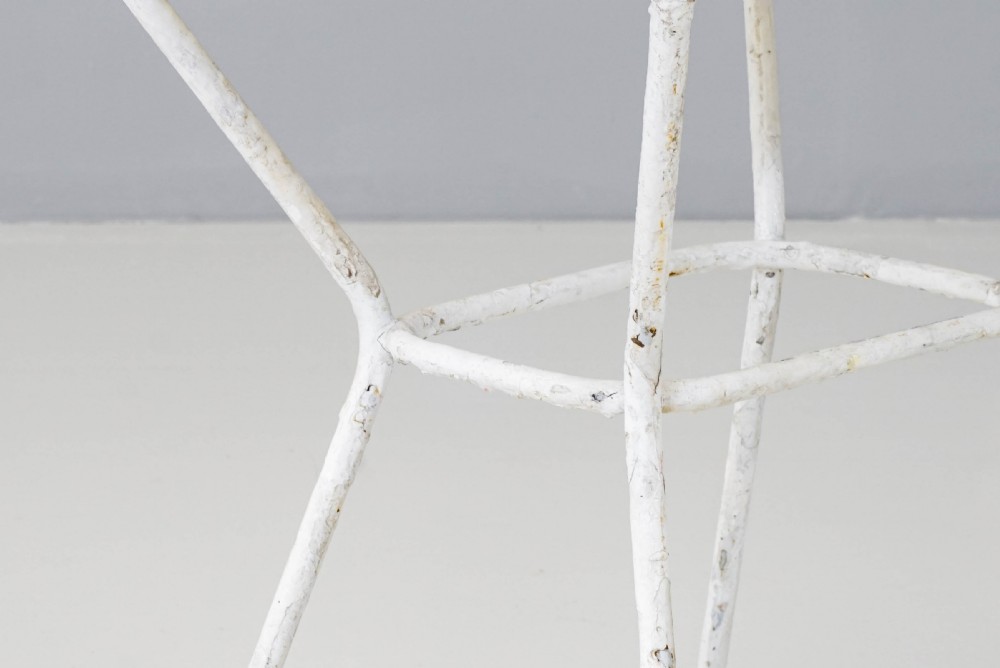 A pair of mid-century white painted metal side tables with perforated mesh rectangular tops and splayed tubular legs connected by a central circular ring. View VI