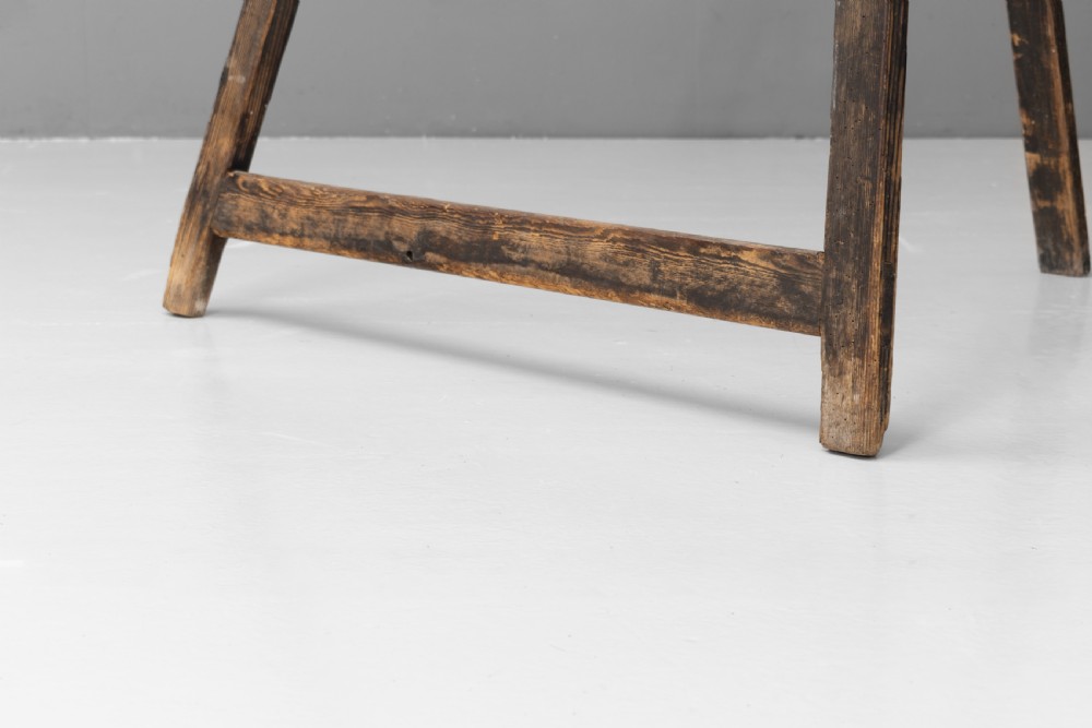 A tall, dark patinated pine A-frame studio easel featuring adjustable rest pegs and a carved decorative upper crossbar. View VI