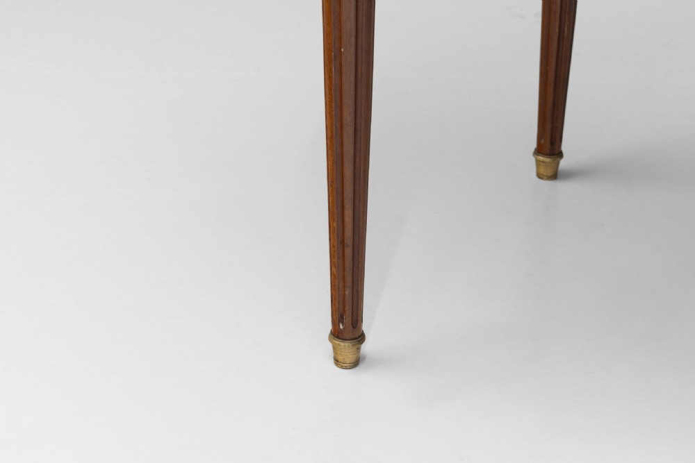 A circular Louis XVI style mahogany bouillotte table featuring a white marble top with a pierced brass gallery rim and fluted tapered legs. View X