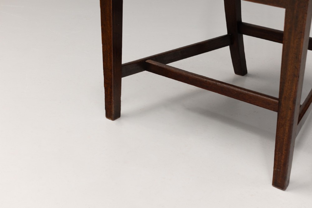 A set of six dark mahogany dining chairs featuring pierced splat backs, square stretchered legs, and light cream upholstered drop-in seats. View VII