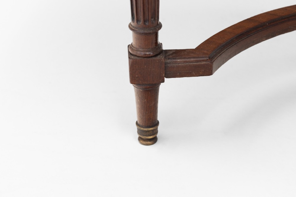 A mahogany kidney-shaped writing desk with a dark leather inset top, gilt-bronze mounts, four side drawers, and fluted legs joined by a curved stretcher. View X