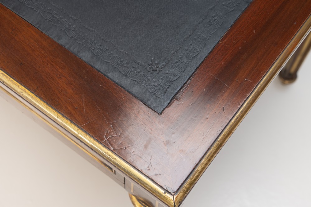 A French Louis XVI style mahogany bureau plat featuring a dark leather writing insert, gilt-bronze trim, frieze drawers, and fluted tapered legs. View V