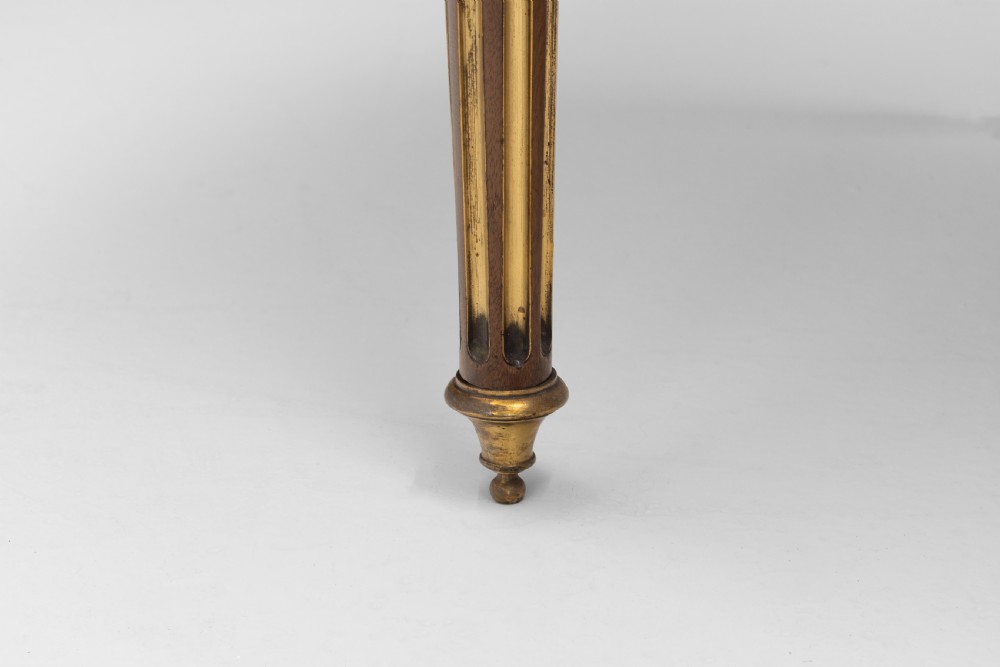 A French Louis XVI style mahogany bureau plat featuring a dark leather writing insert, gilt-bronze trim, frieze drawers, and fluted tapered legs. View VIII
