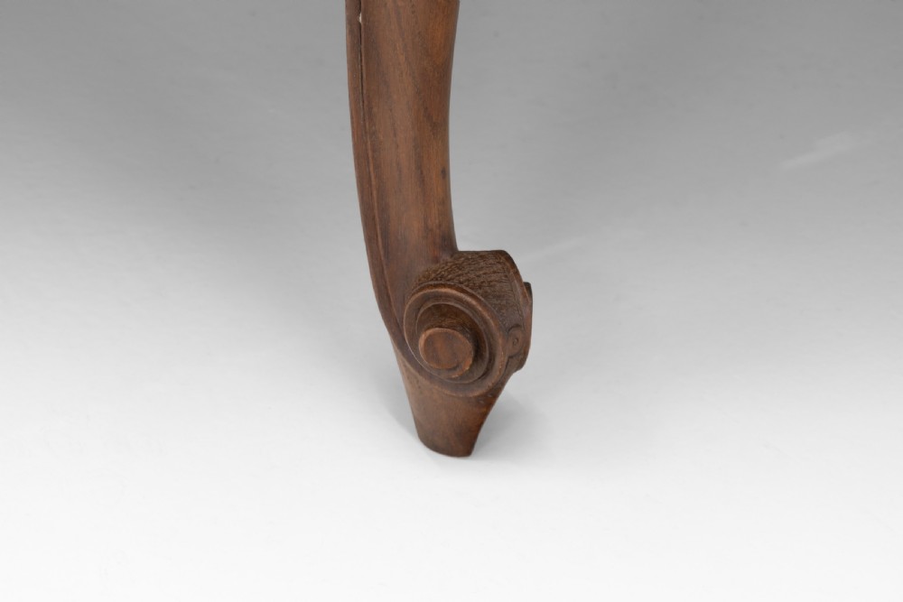 An extendable French Provincial oak dining table with a parquet top, carved shell apron, and cabriole legs ending in scroll feet. View VIII