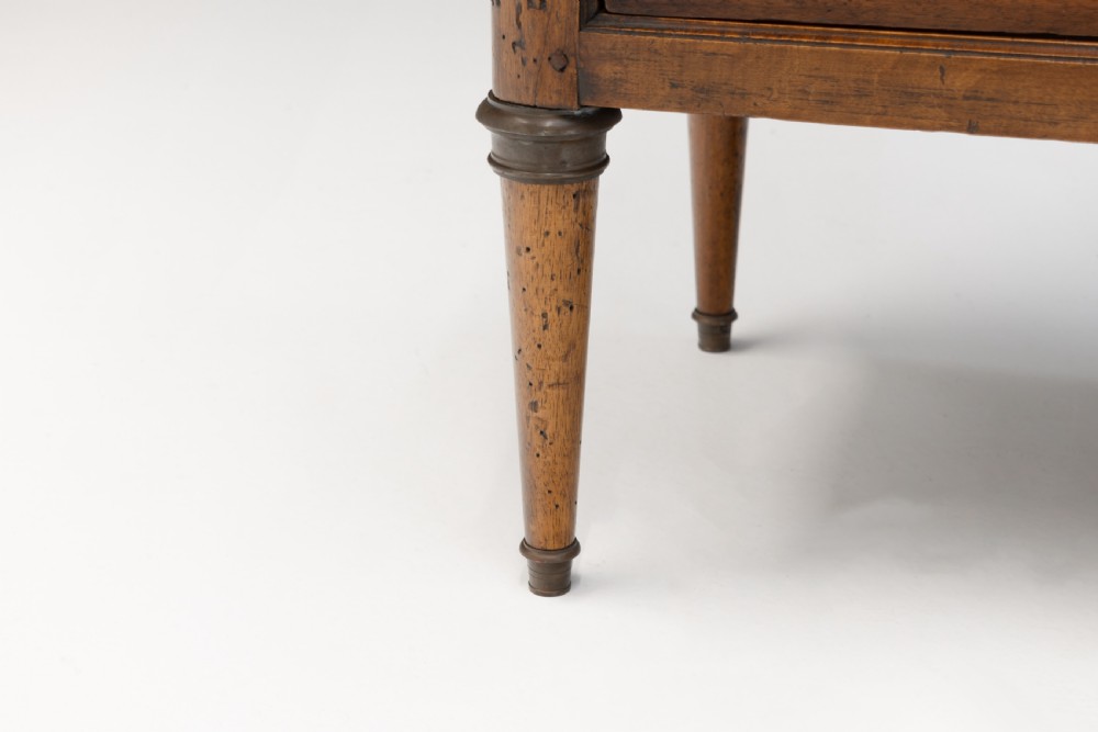 A Neoclassical style three-drawer wooden chest featuring geometric parquetry inlay, brass ring handles, tapered legs, and a white marble top surface. View VII