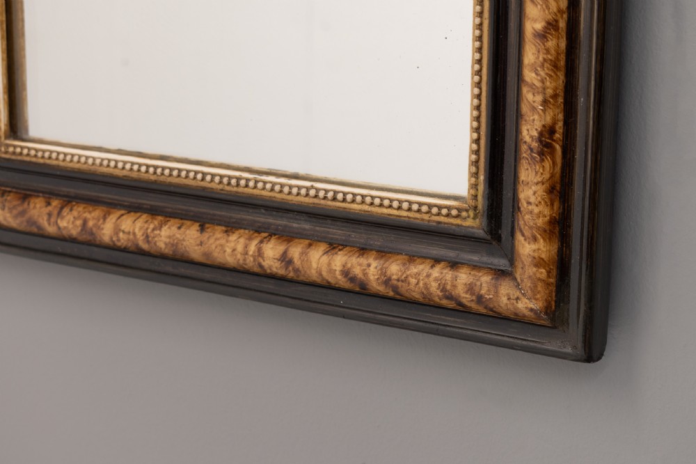 A small Louis Philippe wall mirror featuring rounded upper corners, an ebonised outer profile, figured wood veneer, and a beaded gilt inner border. View II