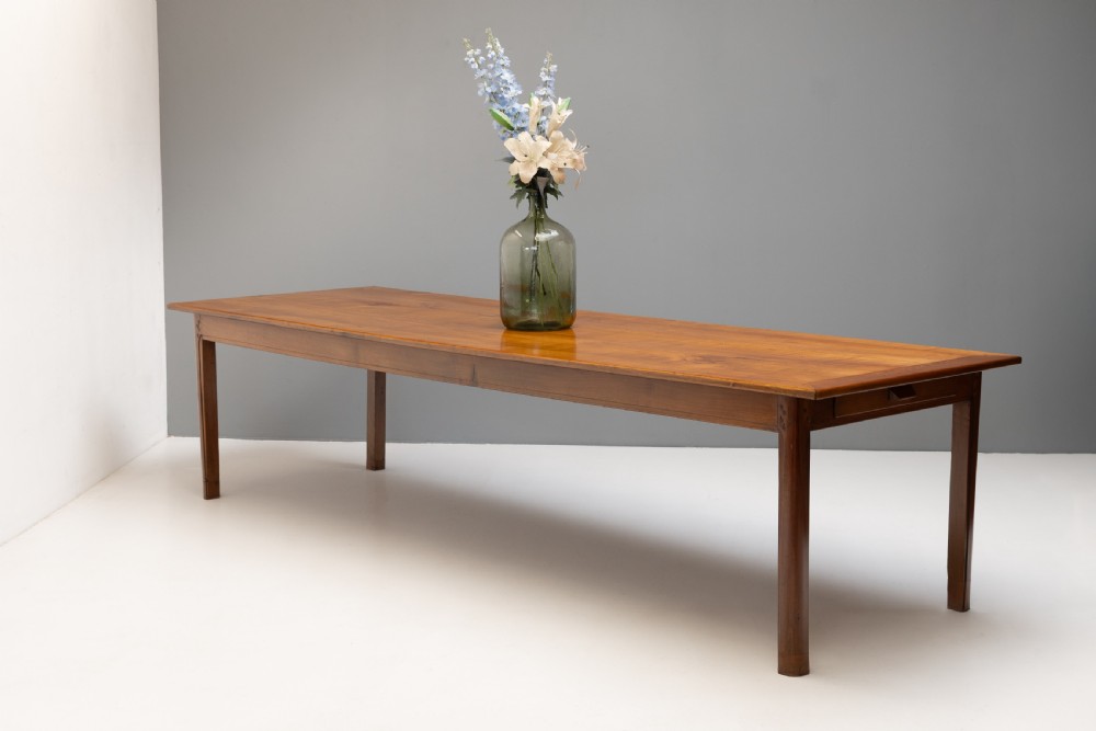 A long rectangular antique cherry wood farm table featuring straight legs and a smooth polished finish. View II