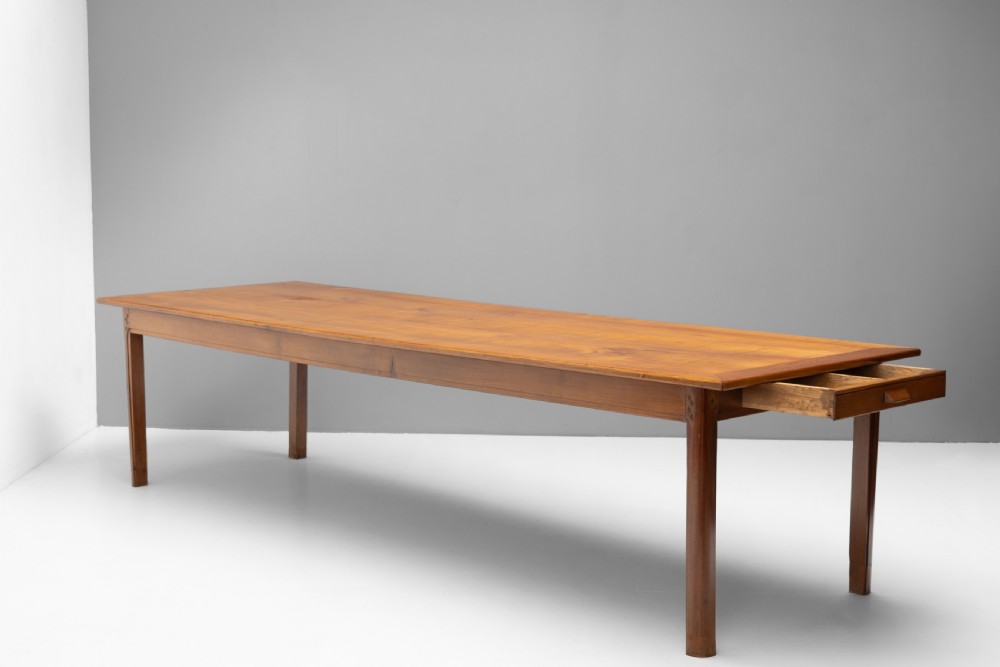 A long rectangular antique cherry wood farm table featuring straight legs and a smooth polished finish. View III
