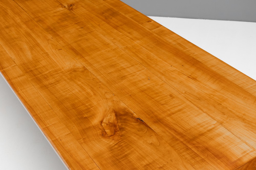 A long rectangular antique cherry wood farm table featuring straight legs and a smooth polished finish. View V
