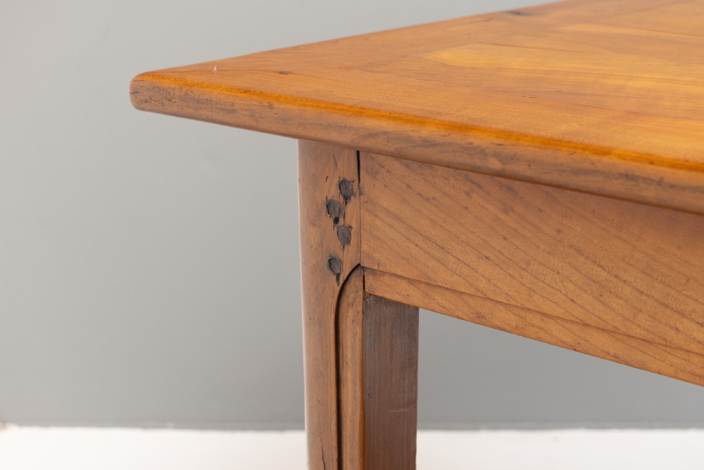 A long rectangular antique cherry wood farm table featuring straight legs and a smooth polished finish. View VIII