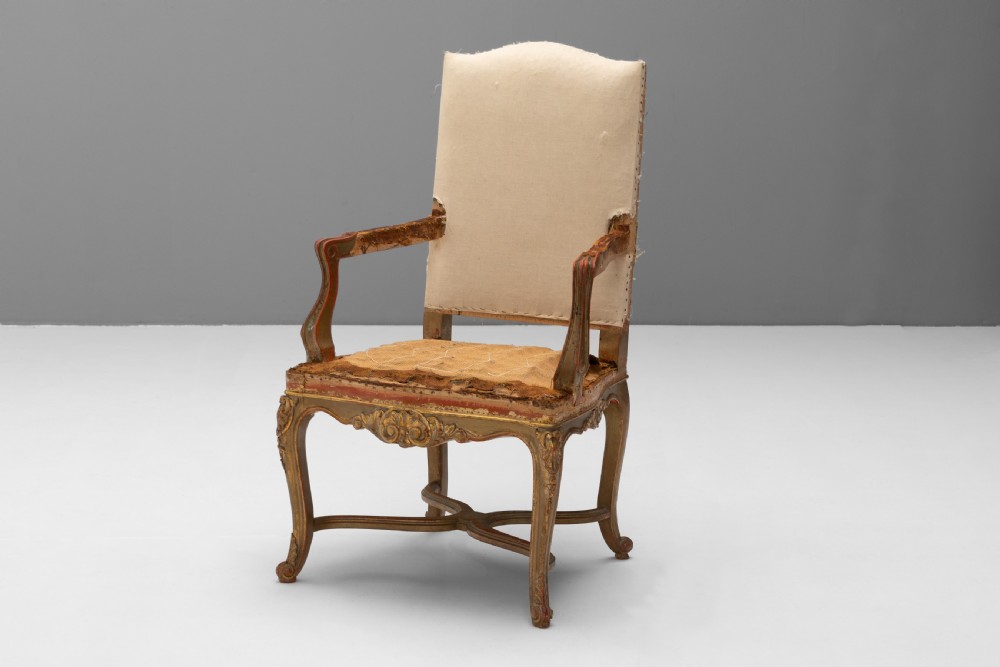 A set of six French gilded dining chairs featuring carved wooden frames, high backrests, and curved cabriole legs. View III