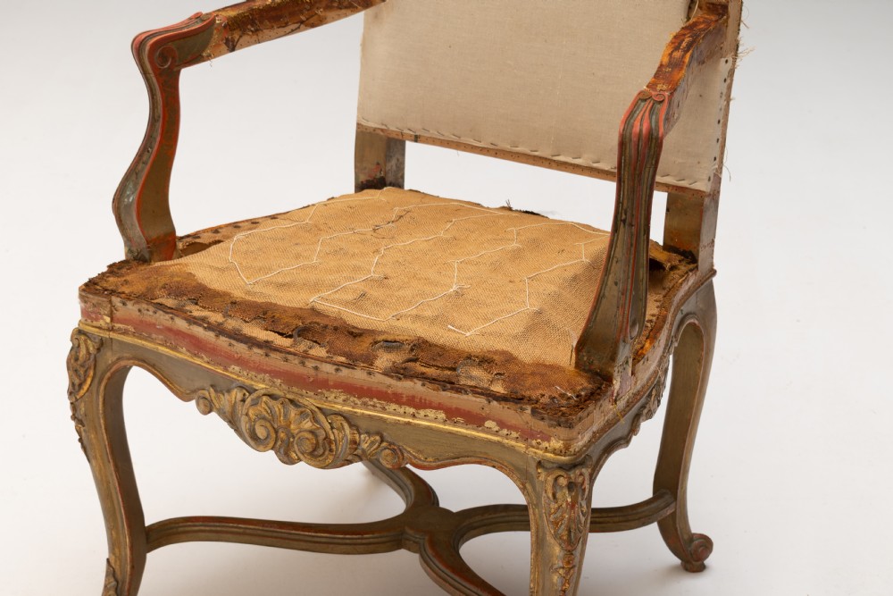 A set of six French gilded dining chairs featuring carved wooden frames, high backrests, and curved cabriole legs. View IV