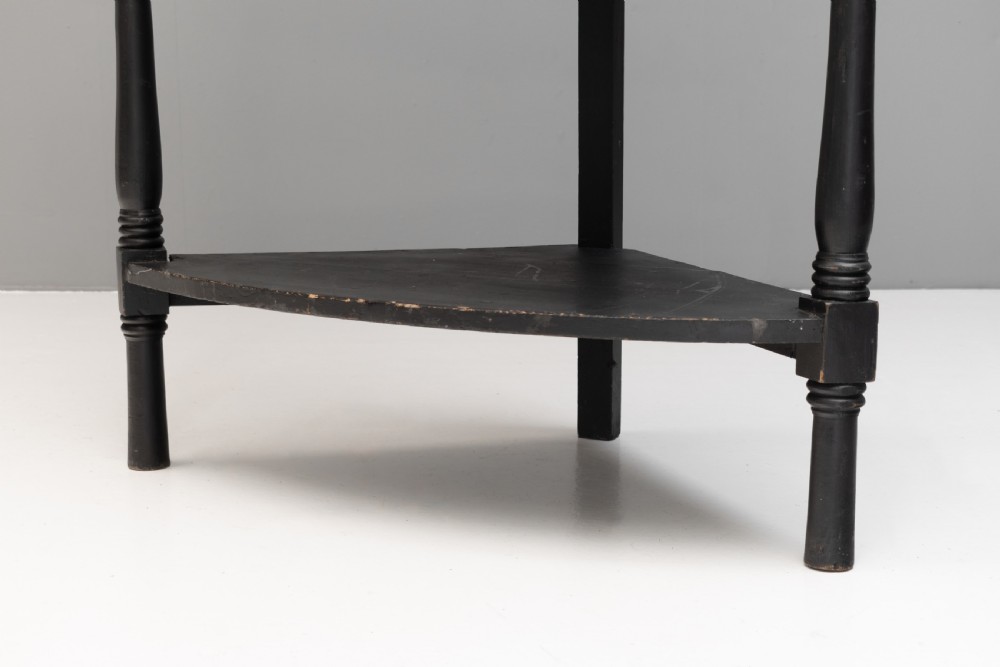 A tall 19th-century ebonised wooden corner shelf unit featuring six tiered triangular shelves and turned spindle supports. View VI