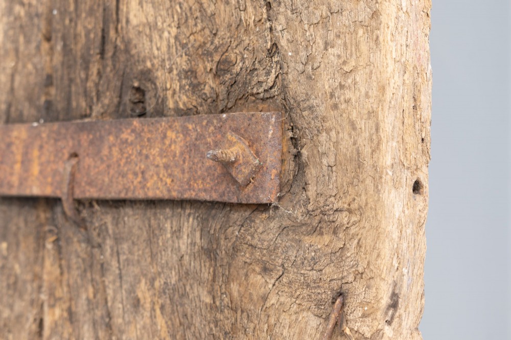 A tall weathered antique oak plank door featuring vertical wooden boards joined with visible iron studs and a natural aged patina. View IX