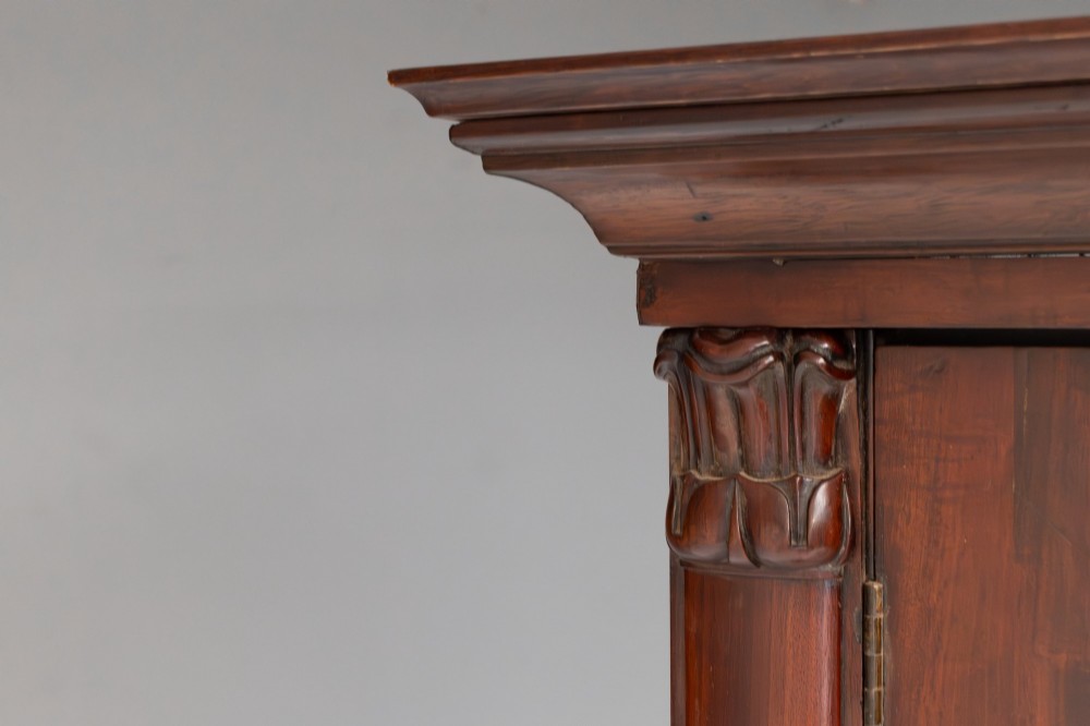 A large mahogany two-tier bookcase featuring twin upper glazed doors with arched glazing bars and a lower cupboard section with carved accents. View XIII