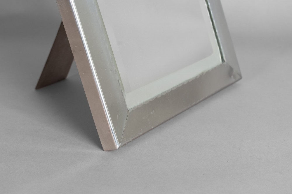 A rectangular silver-plated vanity mirror featuring a bevelled glass edge and an easel back support. View III