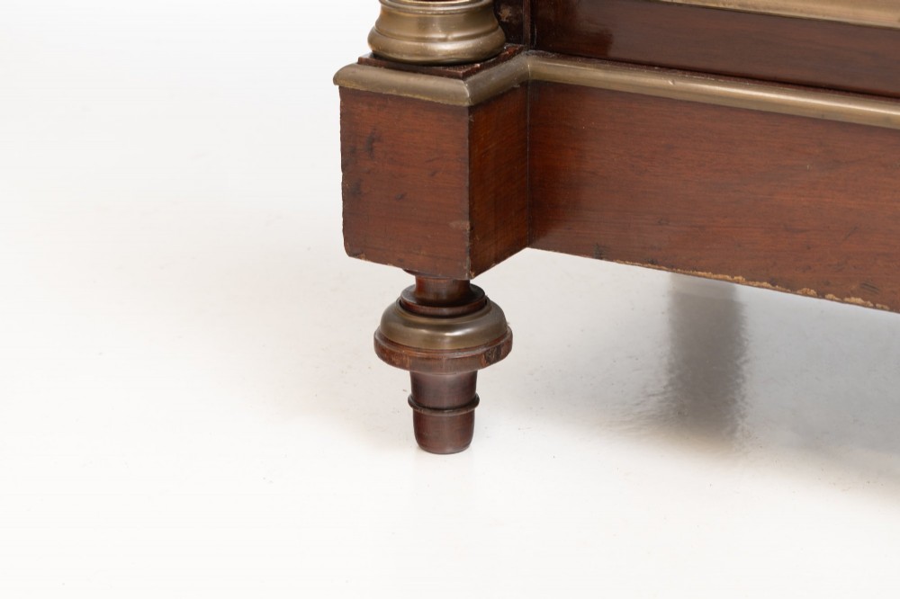 A dark mahogany two-door glazed bookcase featuring brass line inlay, fluted brass-capped columns, and glass doors over solid wood panels. View X