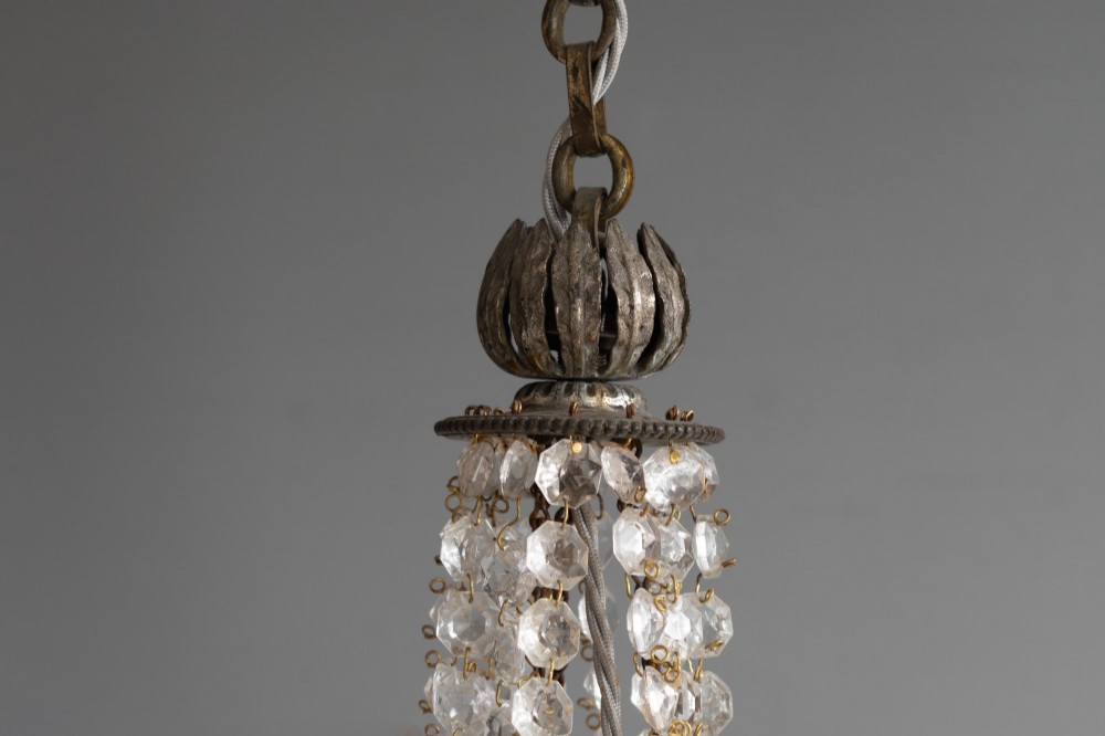 An antique French style crystal chandelier featuring tiered glass prisms, beaded crystal strands, and a decorative aged brass frame. View IV