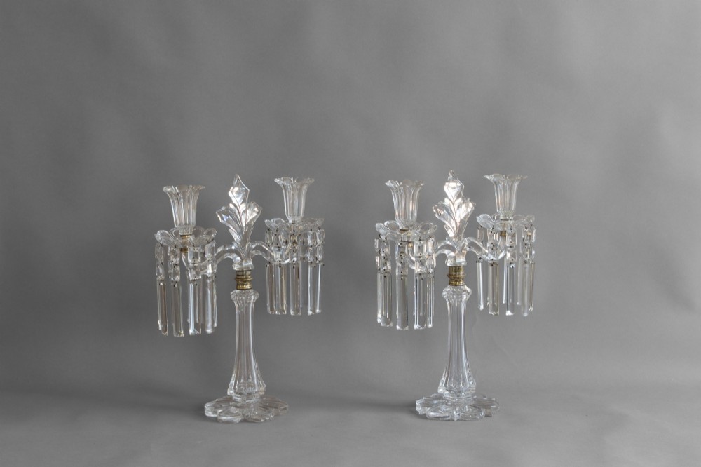 A pair of clear cut glass two-arm candelabras featuring hanging prism drops, fluted stems, and scalloped bases. View II