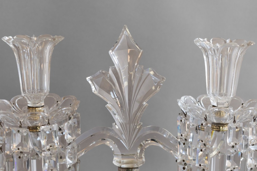 A pair of clear cut glass two-arm candelabras featuring hanging prism drops, fluted stems, and scalloped bases. View VI