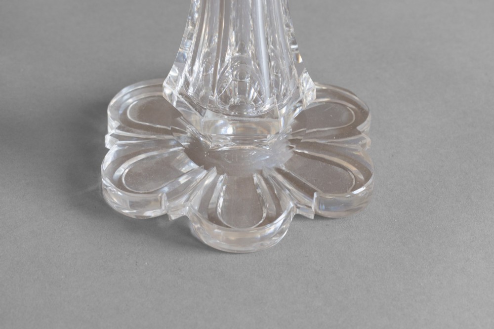 A pair of clear cut glass two-arm candelabras featuring hanging prism drops, fluted stems, and scalloped bases. View VIII