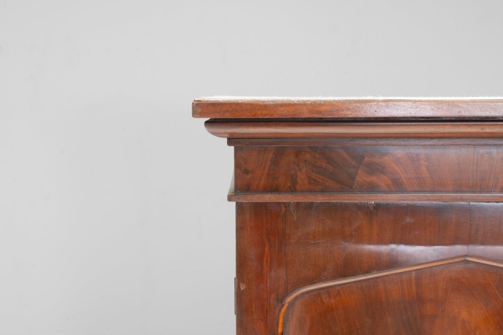 A nineteenth-century two-door flame mahogany cupboard with arched panelled doors and a moulded top cornice. View V