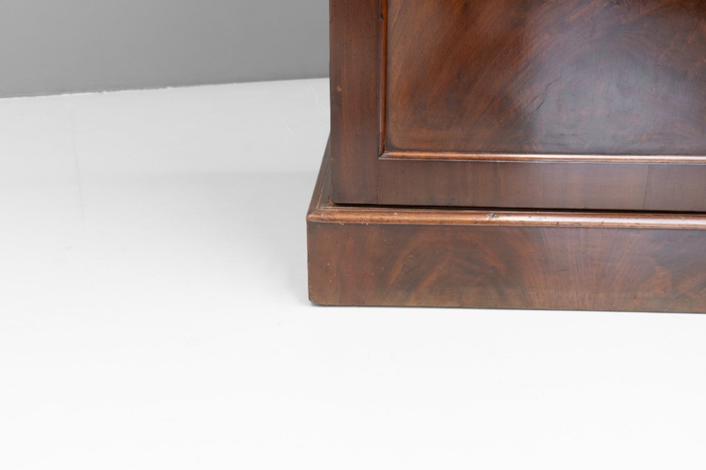 A nineteenth-century two-door flame mahogany cupboard with arched panelled doors and a moulded top cornice. View VII