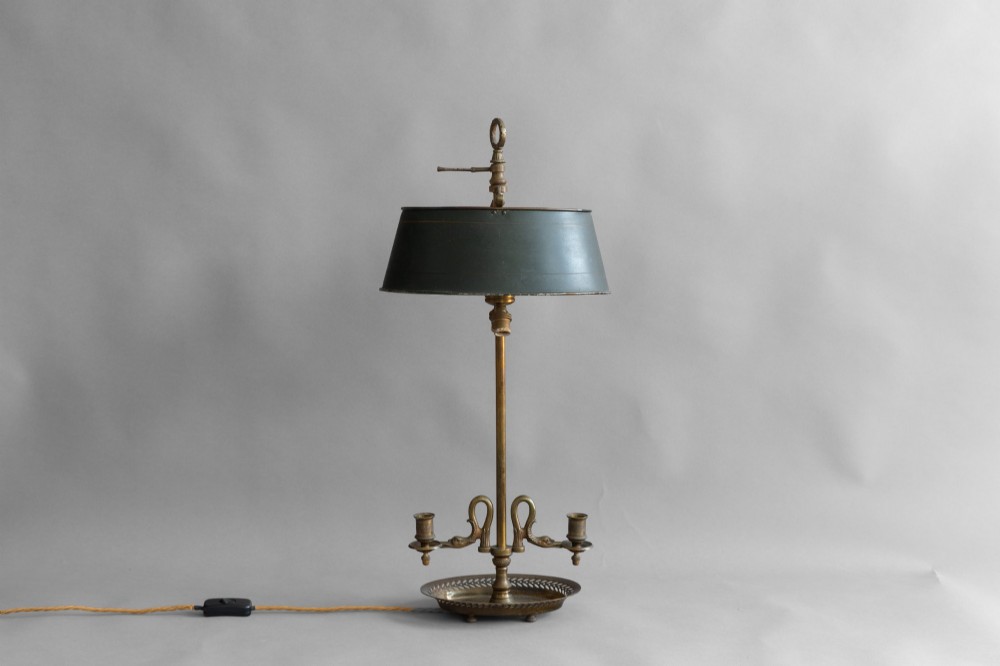 An antique French bouillotte lamp featuring a dark green metal tole shade, twin brass candle sconces, a central adjustment rod with a ring top, and a pierced dish base. View IV