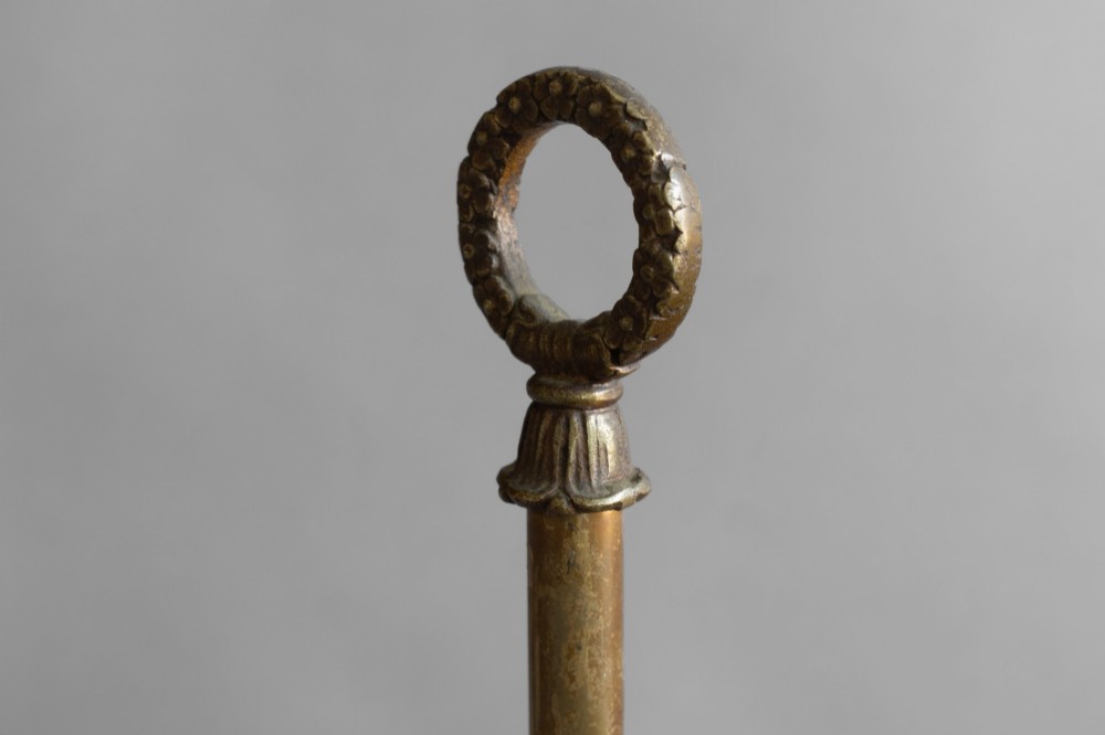 An antique French bouillotte lamp featuring a dark green metal tole shade, twin brass candle sconces, a central adjustment rod with a ring top, and a pierced dish base. View VI