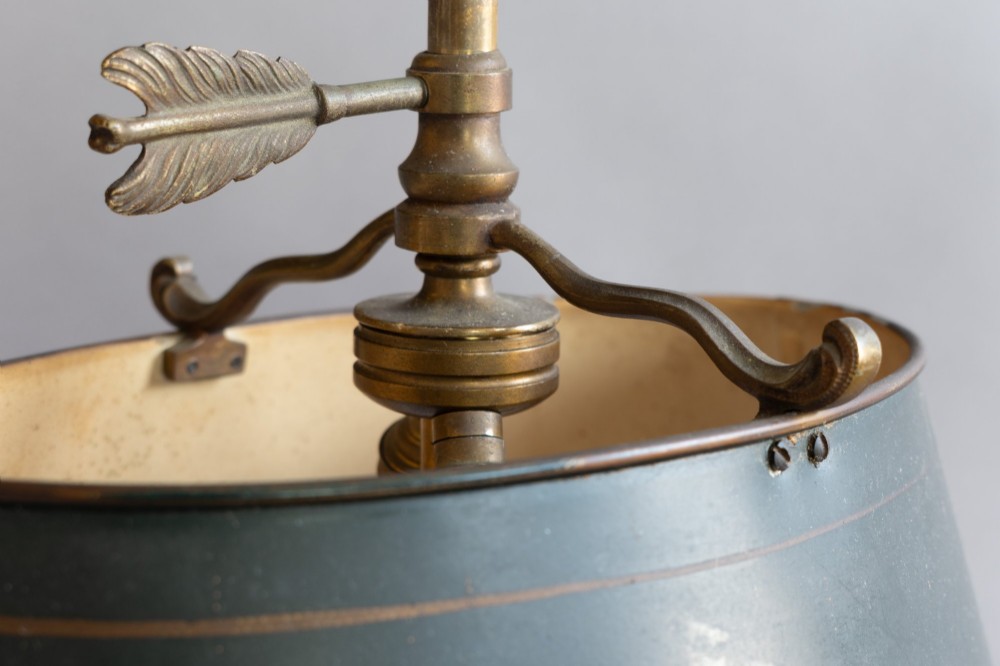 An antique French bouillotte lamp featuring a dark green metal tole shade, twin brass candle sconces, a central adjustment rod with a ring top, and a pierced dish base. View VII