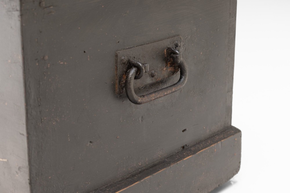 A dark painted rectangular pine storage trunk featuring an open hinged lid, natural pine interior, and iron side handles. View VI