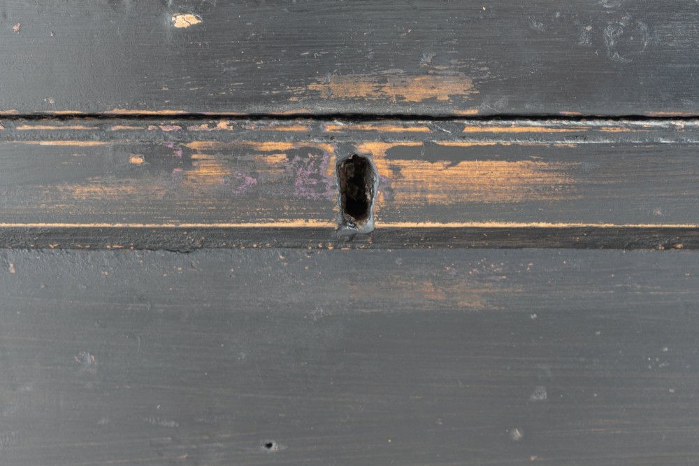 A dark painted rectangular pine storage trunk featuring an open hinged lid, natural pine interior, and iron side handles. View VII