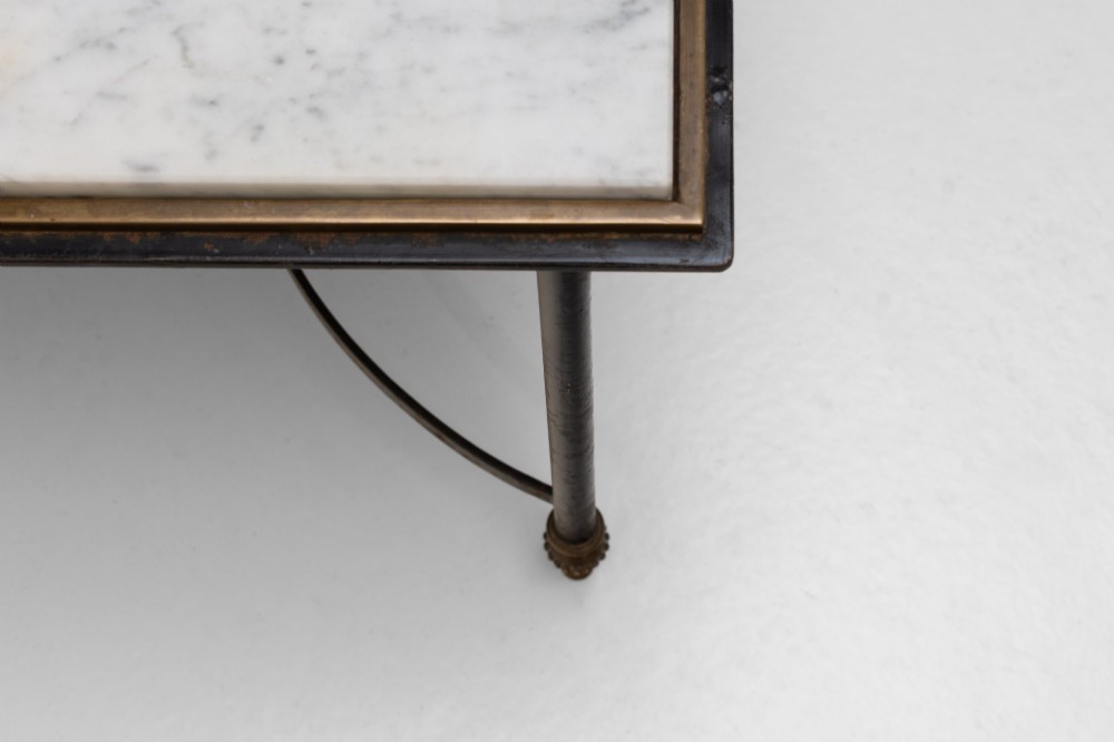 A rectangular coffee table featuring a polished white marble top set upon a black wrought iron frame with curved stretchers and brass finial feet. View V