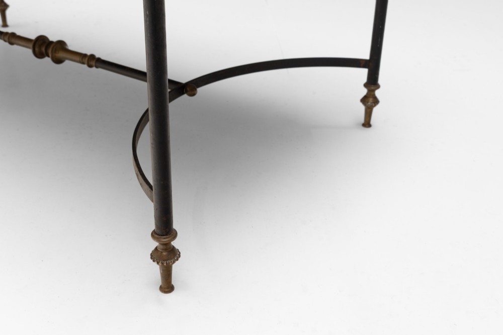 A rectangular coffee table featuring a polished white marble top set upon a black wrought iron frame with curved stretchers and brass finial feet. View VI