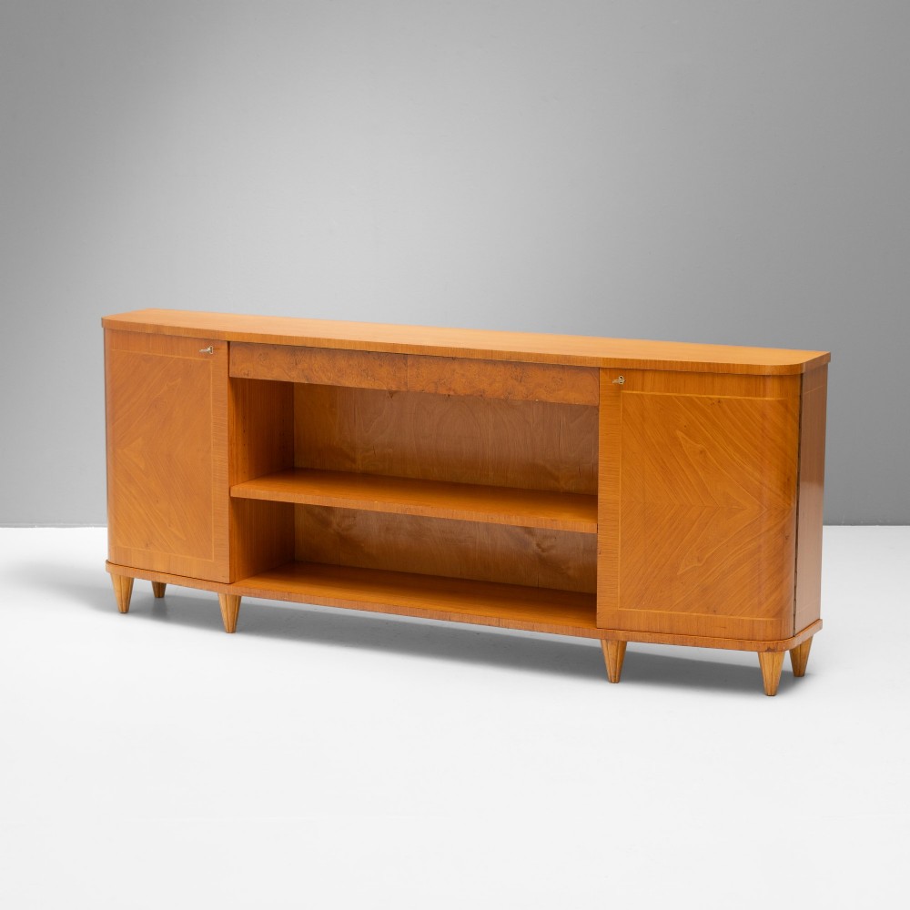 A Swedish Grace birch sideboard featuring chevron parquetry veneer doors, open central shelving, and tapered fluted feet. View II