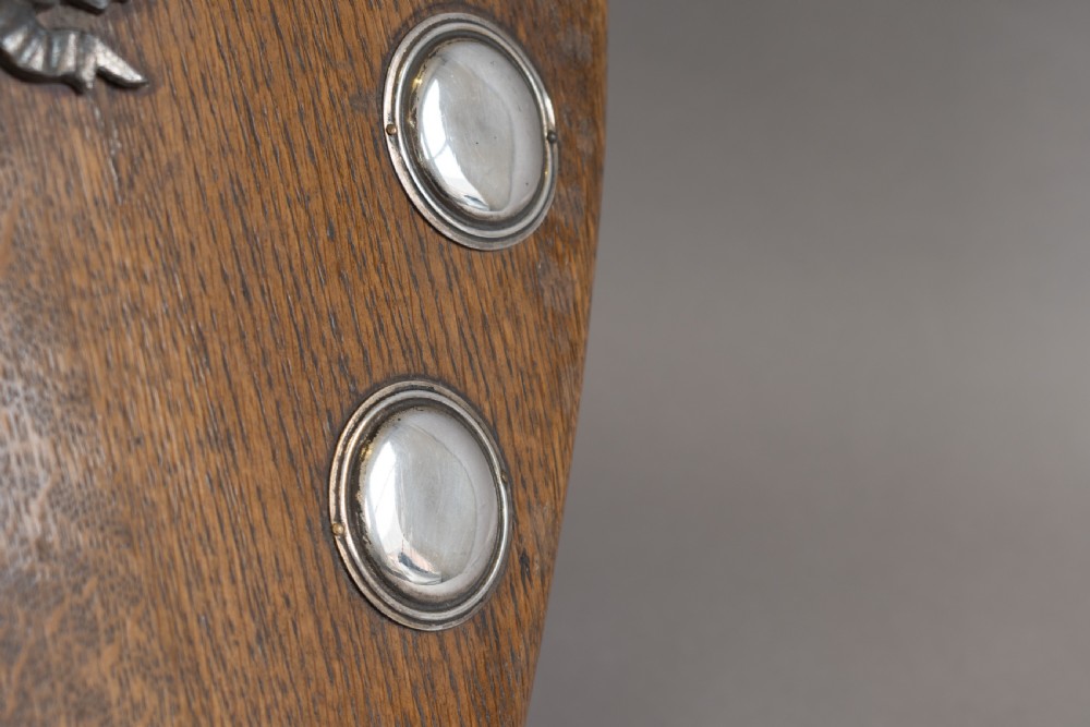 A standing shield-shaped oak presentation trophy featuring an oval silver darts motif surrounded by small silver winner plaques. View VIII