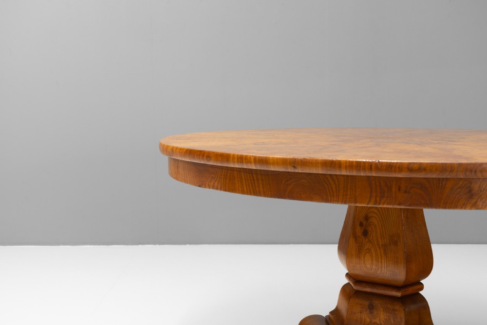 A Victorian tilt-top centre table in golden burr walnut veneer featuring a central starburst inlay and carved tripod pedestal base. View VIII