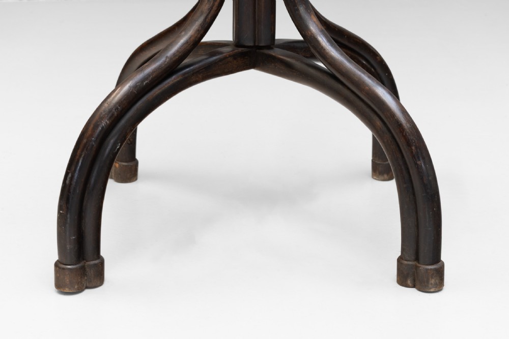 A tall dark brown bentwood coat stand with multiple S-curved hooks at the top, a slender central shaft, an integrated umbrella ring, and four curved splayed legs. View VIII