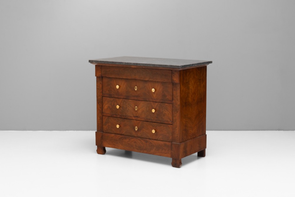 An antique 19th-century French flame walnut commode fitted with a dark grey marble slab top and brass drawer pulls. View III