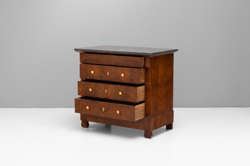 An antique 19th-century French flame walnut commode fitted with a dark grey marble slab top and brass drawer pulls. View V