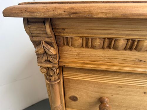 fig 2. A three-drawer waxed pine chest featuring side columns with carved capitals, turned wooden knobs, and inset brass keyhole escutcheons.