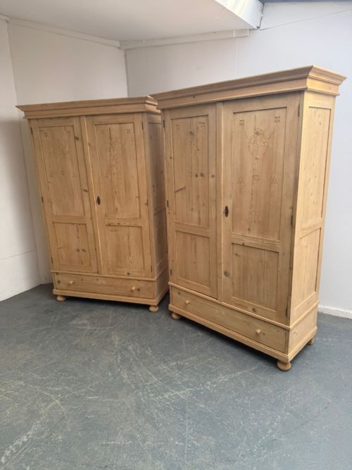 A QUALITY PAIR OF ARTS CRAFTS ANTIQUE PINE KNOCKDOWN WARDROBES TO WAX PAINT