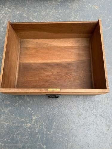 fig 1. A solid light oak Arts and Crafts chest of drawers featuring two short over three long drawers with metal drop handles and panelled sides.