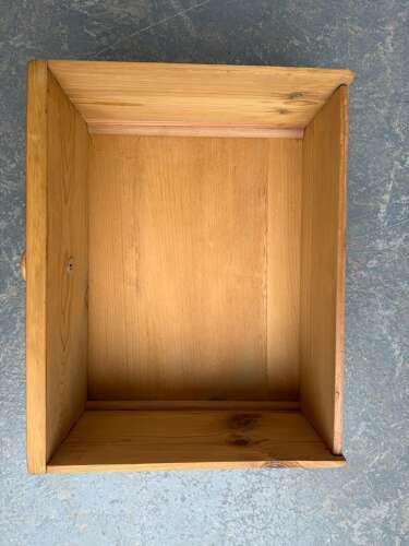fig 1. A Victorian waxed pine dresser base featuring a central panelled cupboard door flanked by six drawers with turned wooden knob handles.