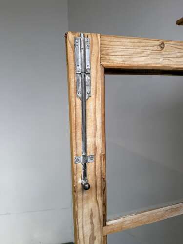 fig 1. A tall Victorian pine glazed two-door bookcase featuring carved corbels, molded top cornice, glass panels, and solid lower panels.