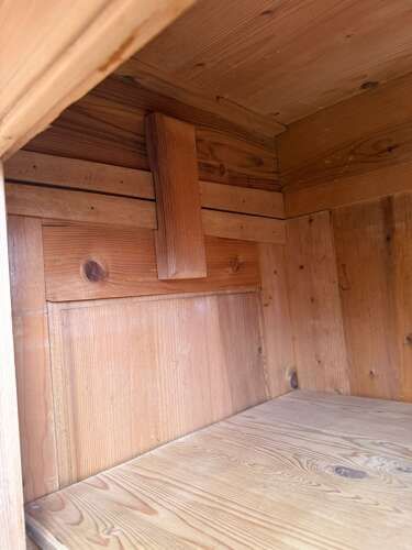 fig 1. A Victorian stripped pine two-door wardrobe featuring a carved dentil cornice, panelled doors, a bottom drawer, and turned feet.