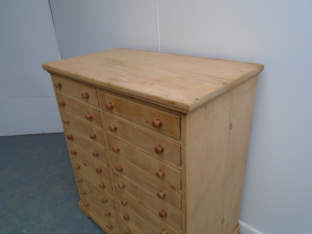 A tall Victorian pine collectors chest featuring two side-by-side columns of shallow drawers with turned wooden knob handles. View II