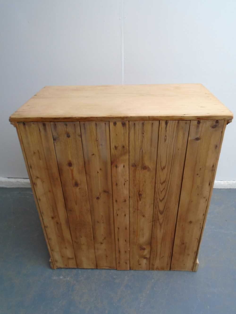 A tall Victorian pine collectors chest featuring two side-by-side columns of shallow drawers with turned wooden knob handles. View XI